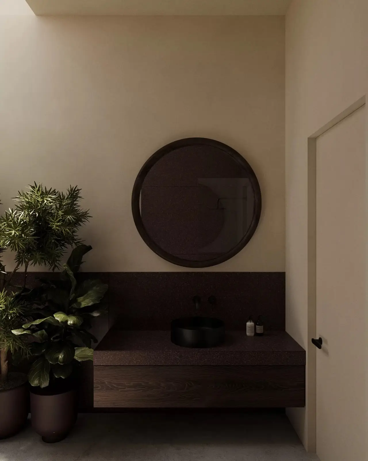 Round mirror and dark stone basin in a Five Stories villa bathroom