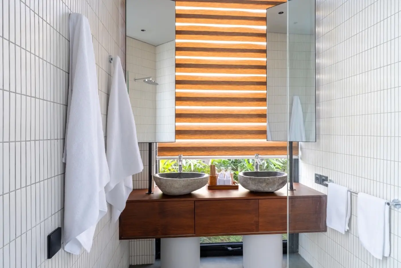Bathroom vanity with louvered window onto the Ubud greenery