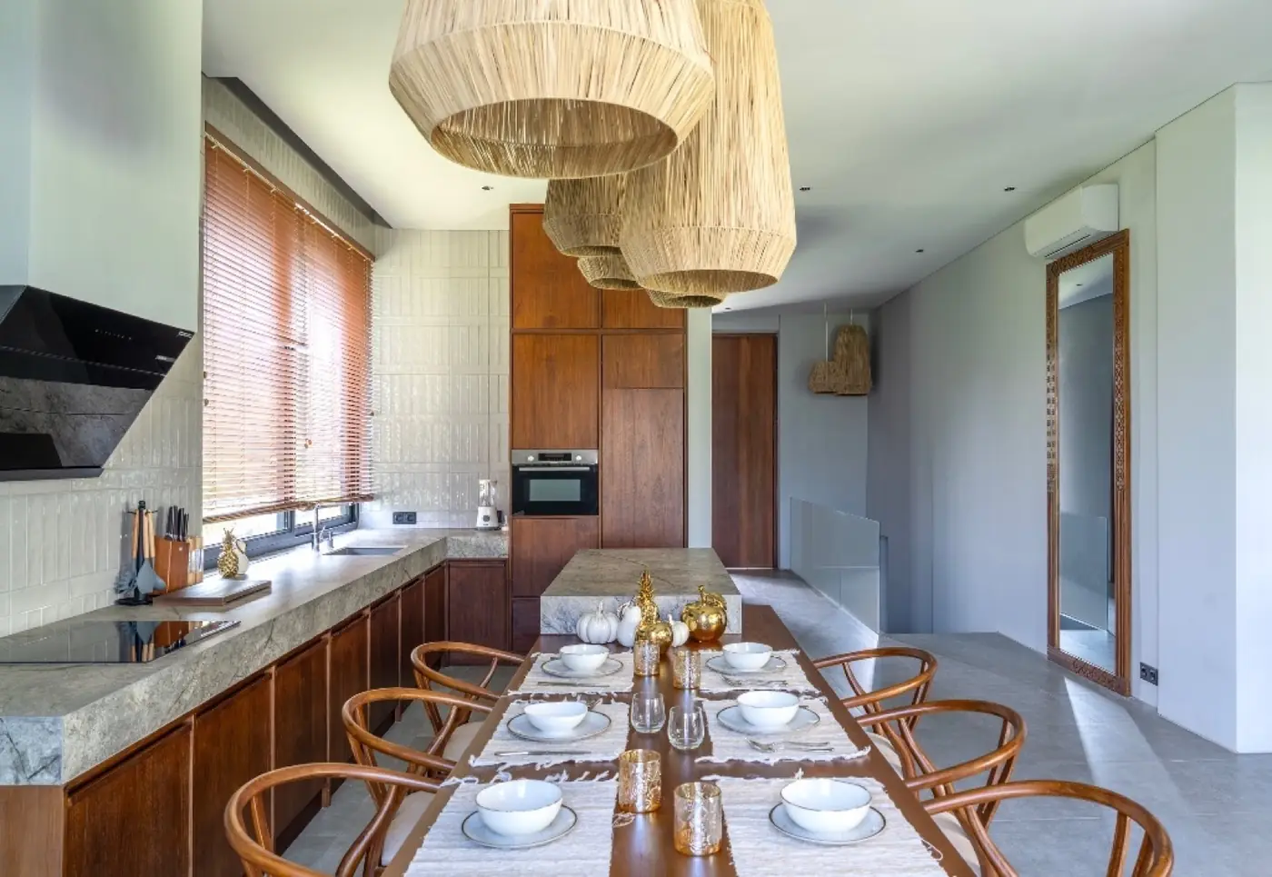 Kitchen and dining area with rattan pendant lights at Meditation House, Ubud