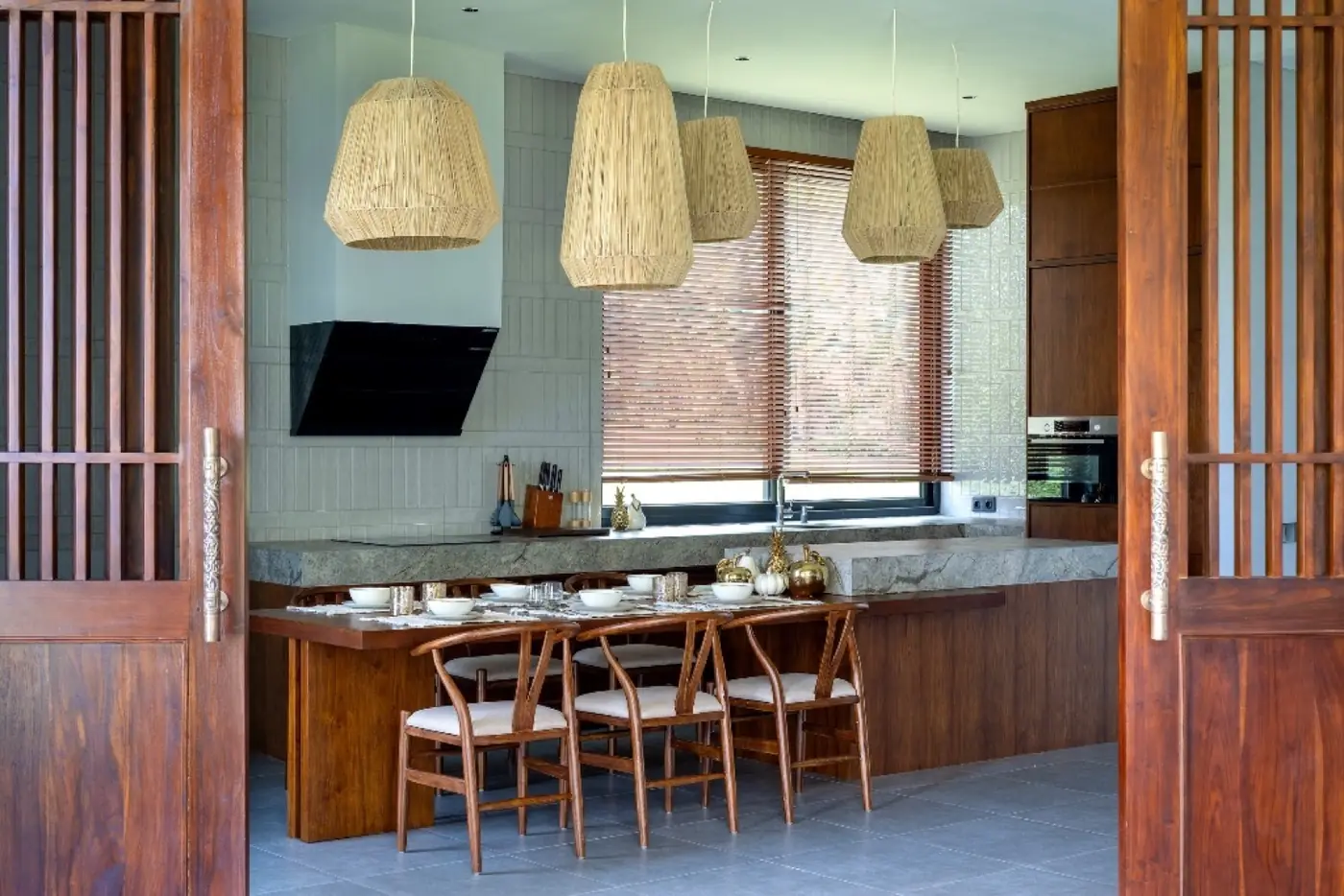 Timber kitchen joinery and woven pendants at Meditation House, Ubud