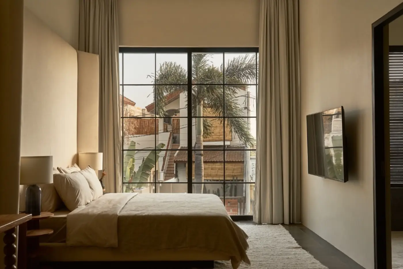 Bedroom with full-height window in an Umalas villa