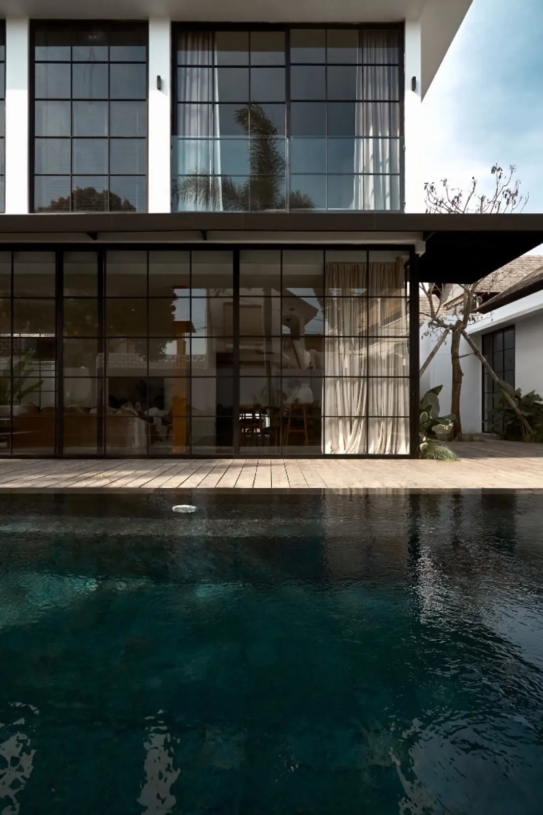 Pool deck and glazed living pavilion at Umalas Villas