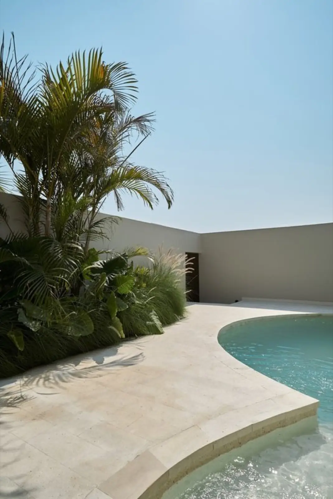 Courtyard pool and tropical planting between the Vesna townhouses
